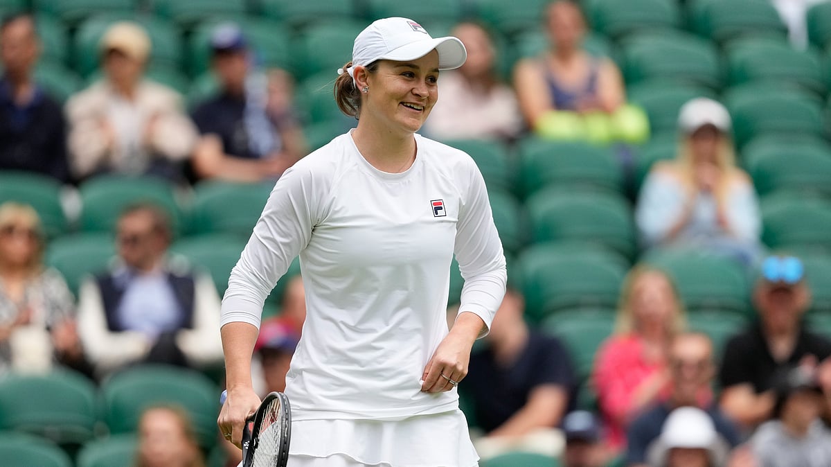 (AP Photo/Kirsty Wigglesworth) : Australia's Ash Barty reacts during her invitation doubles match with compatriot Casey Dellacqua against Andrea Petkovic of Germany and Magdelena Rybarikova of Slovakia at the Wimbledon tennis championships in London, Wednesday, July 10, 2024. 